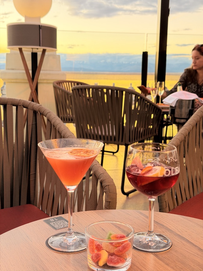 Cocktails on a table at 360 Sky Bar Madrid during sunset