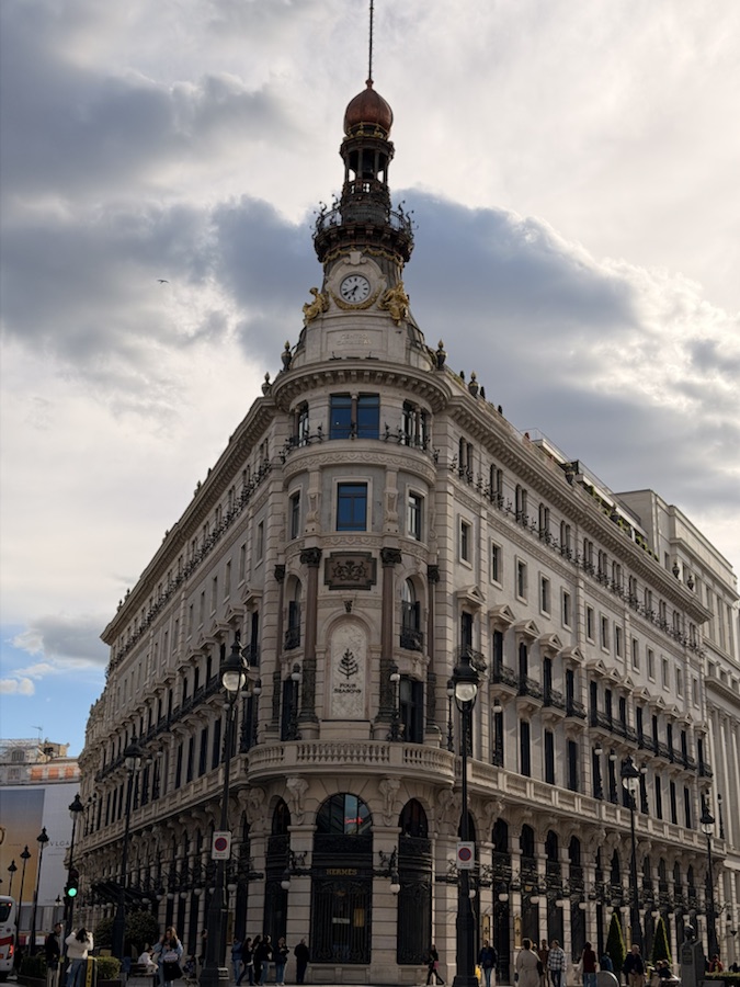 Historic building on Gran Via in Madrid under a cloudy sky