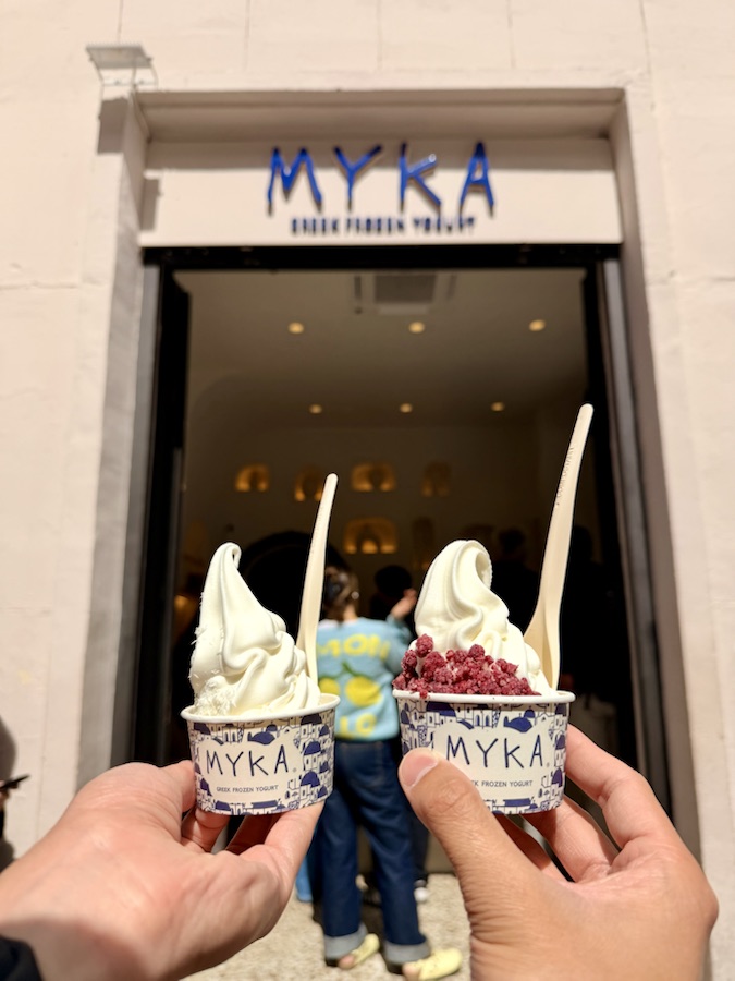 Two cups of MYKA Greek frozen yogurt held outside the Madrid shop