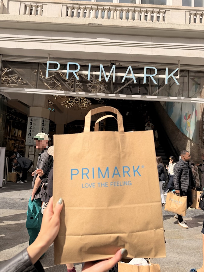 A Primark shopping bag held outside Primark on Gran Via in Madrid