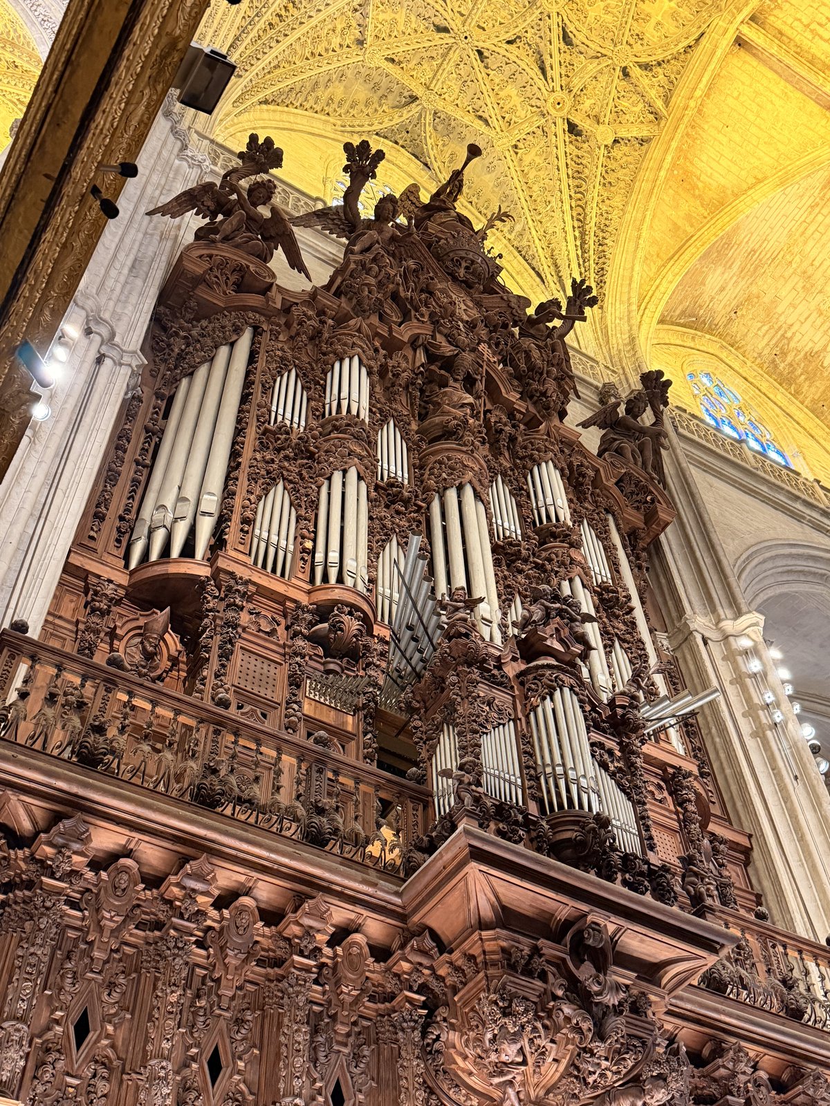 The carved organ and Gothic ceiling inside Seville Cathedral