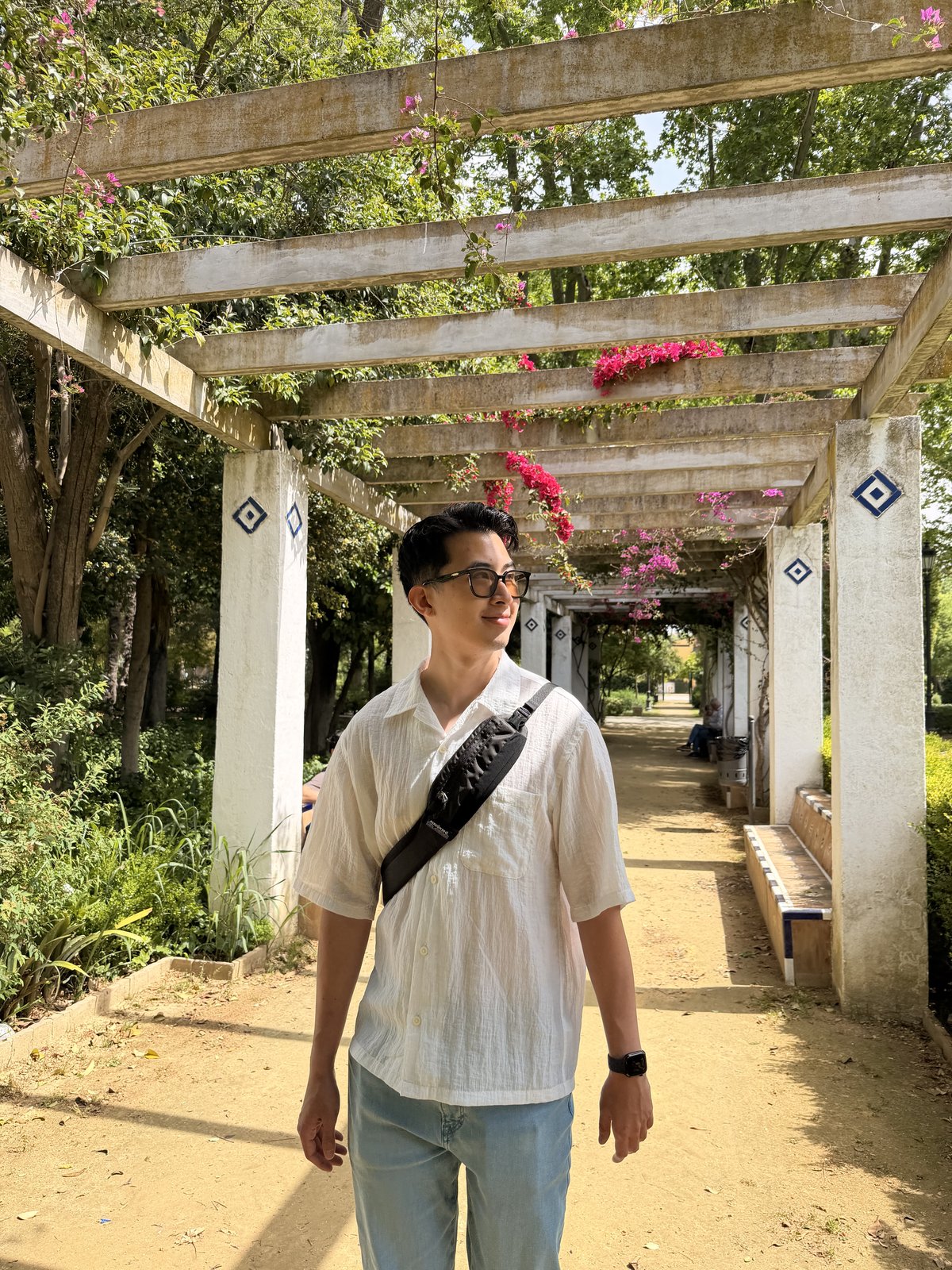 A shaded pergola walkway draped in bougainvillea in María Luisa Park