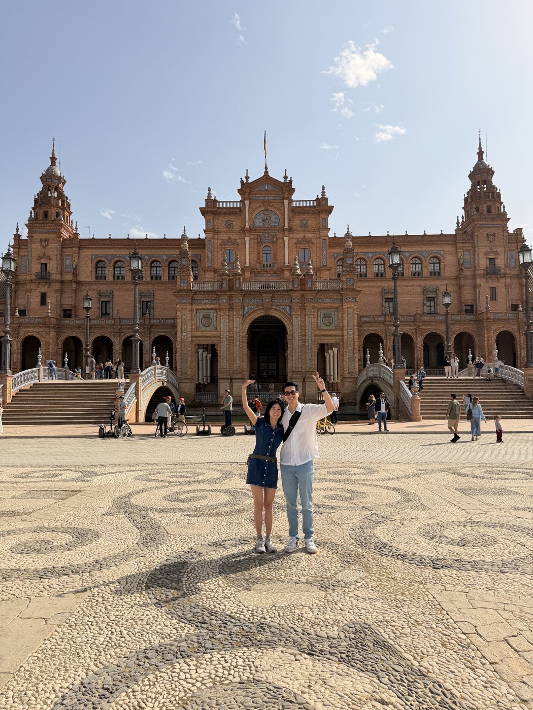 Standing in front of the curved tiled architecture at Plaza de España in Seville
